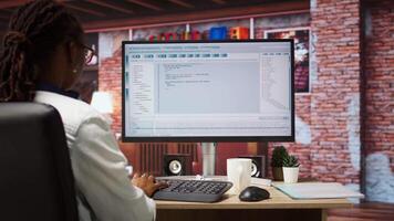 Software developer at PC coding, creating software, implementing algorithms. IT expert in home office working with code editor, building applications, optimizing performance, camera A panning shot video
