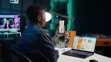 Woman in home office holding teleconference meeting with coworkers using smartphone, brainstorming ideas. Remote worker in online phone videocall with colleagues analyzing research, camera B video