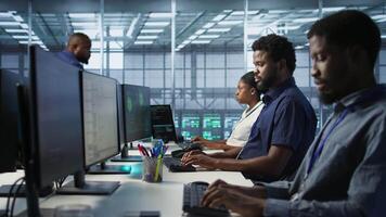 Server room engineers panicking after seeing disaster recovery plans fail, unable to avoid downtime. Stressed data center workers frightened after seeing performance drop while monitoring it, camera A video