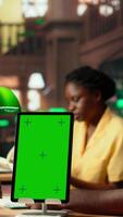 Vertical Black college students reading class notes next to copy space screen, studying together at the campus library. Team of pupils working on self improvement and education, study time. Camera B. video