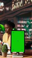 Vertical Black college students reading class notes next to copy space screen, studying together at the campus library. Team of pupils working on self improvement and education, study time. Camera A. video