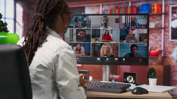 Employee greeting coworkers during videocall from home desk, organizing calendar appointments. Worker preparing for corporate event, doing remote videoconference meeting with colleagues, camera B video