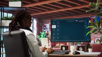 Woman at home using generative artificial intelligence website generating videos using diffusion models. Person drinking coffee and using AI virtual assistant producing clips, camera A