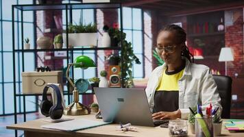 Worker at home starting job shift, opening laptop to analyze data at desk, compiling analytical reports. Remote employee beginning tasks, using notebook device, writing down information, camera A video