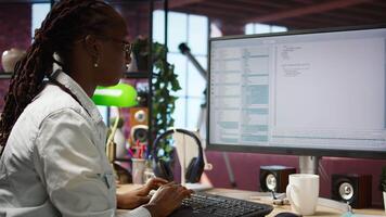 Woman feeling worried while looking at UI on PC screen, having trouble executing programming code. Anxious IT developer concerned by errors popping up while testing code in apartment, camera A video
