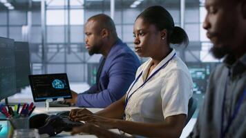 Woman putting headphones on in server room, developing disaster recovery plans ensuring minimal downtime. Engineer listening music in data center, using data analytics to monitor performance, camera A video