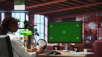 Teleworker using green screen PC in home office to write emails. Remote worker typing on mockup computer keyboard, composing documents in order to deliver finalized project paperwork, camera A video