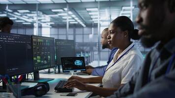 Data center engineer wearing headphones enjoying songs, maintaining company network infrastructure. Woman in server hub listening music while ensuring optimal system performance, camera A video