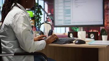 Coder at workstation programming on PC, writing lines of code, using development tools, feeling stressed. Woman in home office having deadline, stressed to finish debugging software, camera A video