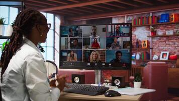 Employee greeting coworkers during videocall from home desk, organizing calendar appointments. Worker preparing for corporate event, doing remote videoconference meeting with colleagues, camera A video