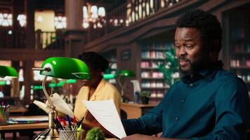 African american college student feels frustrated and overwhelmed with the learning struggles, worried depressed pupil struggling to memorize information from class notes. Camera A. video