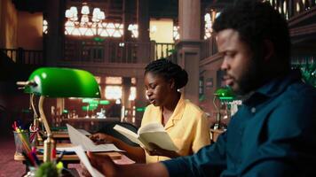 Diligent students reciting poetry together at the campus library, studying for a literature exam. Team of pupils showcasing productivity and commitment for self improvement. Camera A. video