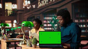 Scholars preparing for their upcoming exams next to isolated copy space, meeting in a public library and studying together. Students showcasing the educational progress, student life. Camera A. video
