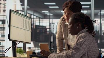 African american CEO and employee review company numbers, creating a roadmap that includes goals, strategies and resource allocation management. Specialists meet corporate objectives. Camera A. video