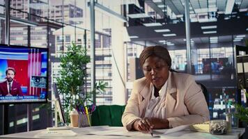 Black corporate owner drafting architectural sketches for a new office, looking to relocate startup headquarters. Collaborates with contractors to design a functional creative workspace. Camera B. video