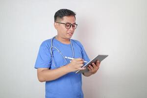 Getting loads more done in digital format. Shot of a young doctor using a digital tablet in a hospital. photo