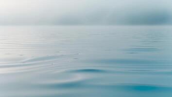 The image is of a calm body of water with a blue color. photo