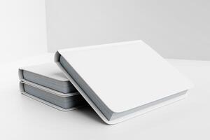 Stack of Blank Hardcover Books in Minimalist White Setting photo