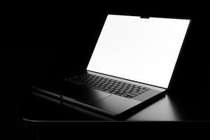 A laptop computer with a blank screen on a table photo