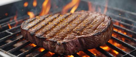 Macro shot of a marbled steak grilling to juicy perfection on a flaming grill with golden grill marks. photo
