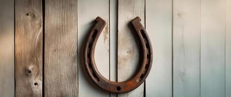 old rusty horseshoe on wooden background. photo