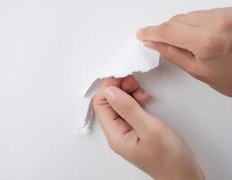 Breaking the Rules Hands Ripping a Paper Document on White Background photo