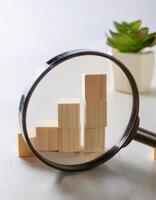 Conceptualizing Data Analysis with Wooden Blocks and Magnifying Glass photo