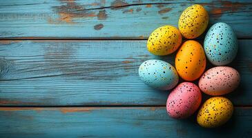 A bunch of colorful eggs are sitting on a wooden table. The eggs are of different colors, including blue, pink, and yellow. The arrangement of the eggs creates a playful and cheerful atmosphere photo