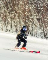 Close up young advanced professional boy skier training freeze motion ski downhill in Mestia hatsvali ski resort outdoors on fresh snow day enjoy active winter holidays photo