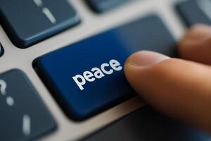 Focused finger pressing peace key on modern keyboard reflecting the importance of harmony in communication photo
