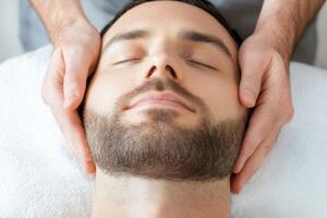 Man receiving a relaxing facial massage therapy at a spa for rejuvenation and stress relief photo
