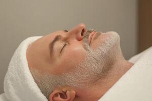 Man relaxing during a facial treatment at a spa, enjoying a serene moment of self-care and rejuvenation photo
