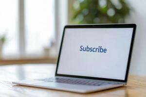 Laptop displaying a subscribe message in a bright room with plants during daylight hours photo
