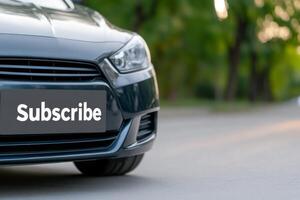 Close-up view of a car with a subscribe sign in a natural setting during the day photo