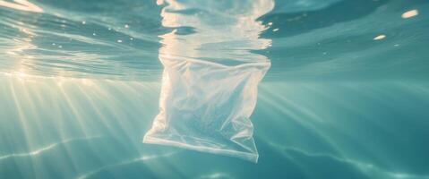 Underwater view of a plastic bag with light rays penetrating through ocean water. photo