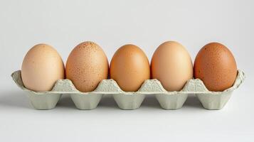 Row of colorful eggs in a carton with various shades and speckles highlighting their natural beauty photo