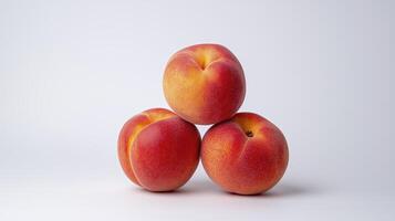 Three ripe peaches stacked on a white background showcasing their vibrant colors and natural textures photo