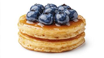 Delicious stack of golden pancakes topped with fresh blueberries and syrup on a clean white background photo