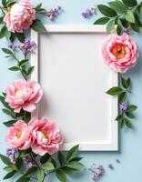Pink peonies flowers frame on blue background with copy space for text photo