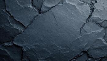 A dark blue stone wall with cracks photo