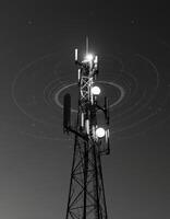 A cell tower with multiple antennas and a black and white photo
