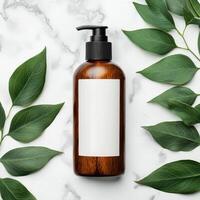 A stylish brown bottle surrounded by green leaves on a marble surface. photo