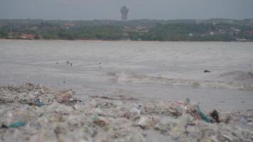 Ocean Plastic Waste Pollution, Very Dirty Polluted Trash Beach in Kedonganan Bali Indonesia Environmental Ecological Crisis Global Warming Garuda Wisnu Kencana video
