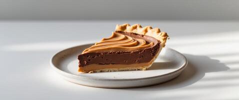 Delicious slice of chocolate peanut butter pie on plate. photo