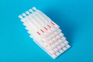 Tubes with medicine on a blue background. Concept of a laxative for the treatment of constipation in the intestines. Restoration of intestinal microflora, close-up. Copy space for text photo