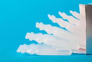 Tubes with a new generation probiotic on a blue background for the treatment of intestinal diseases. Restoration of intestinal microflora during dysbacteriosis. Copy space for text, metabiotic photo