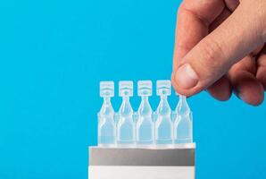 Tubes with a new generation probiotic on a blue background for the treatment of intestinal diseases. Restoration of intestinal microflora during dysbacteriosis. Copy space for text photo