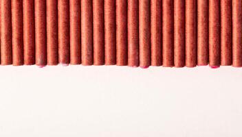 A bunch of firecrackers with red sulfur. Set of pyrotechnics, explosion hazard, macro. Copy space for text photo