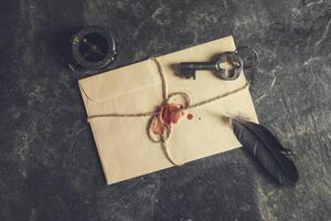 An envelope with a key, a feather and a seal photo