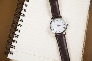 watch on notepad on table. photo